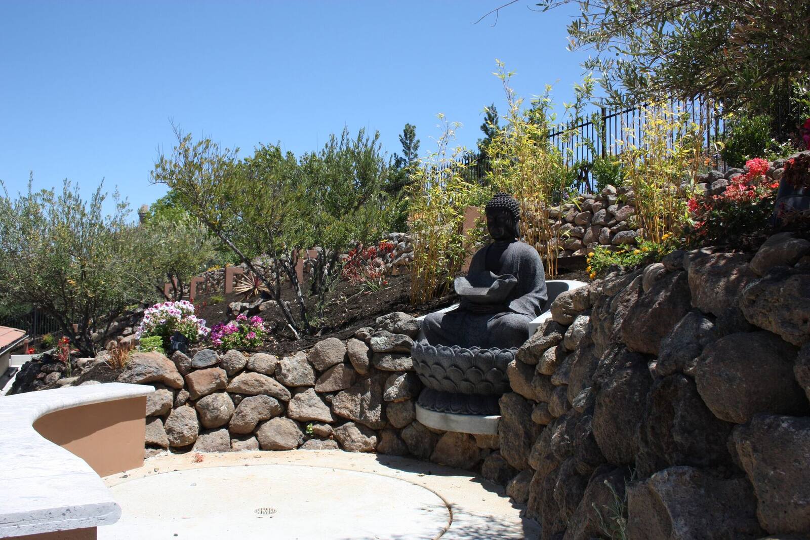 A quiet sculptural retreat set into the hillside planting.
