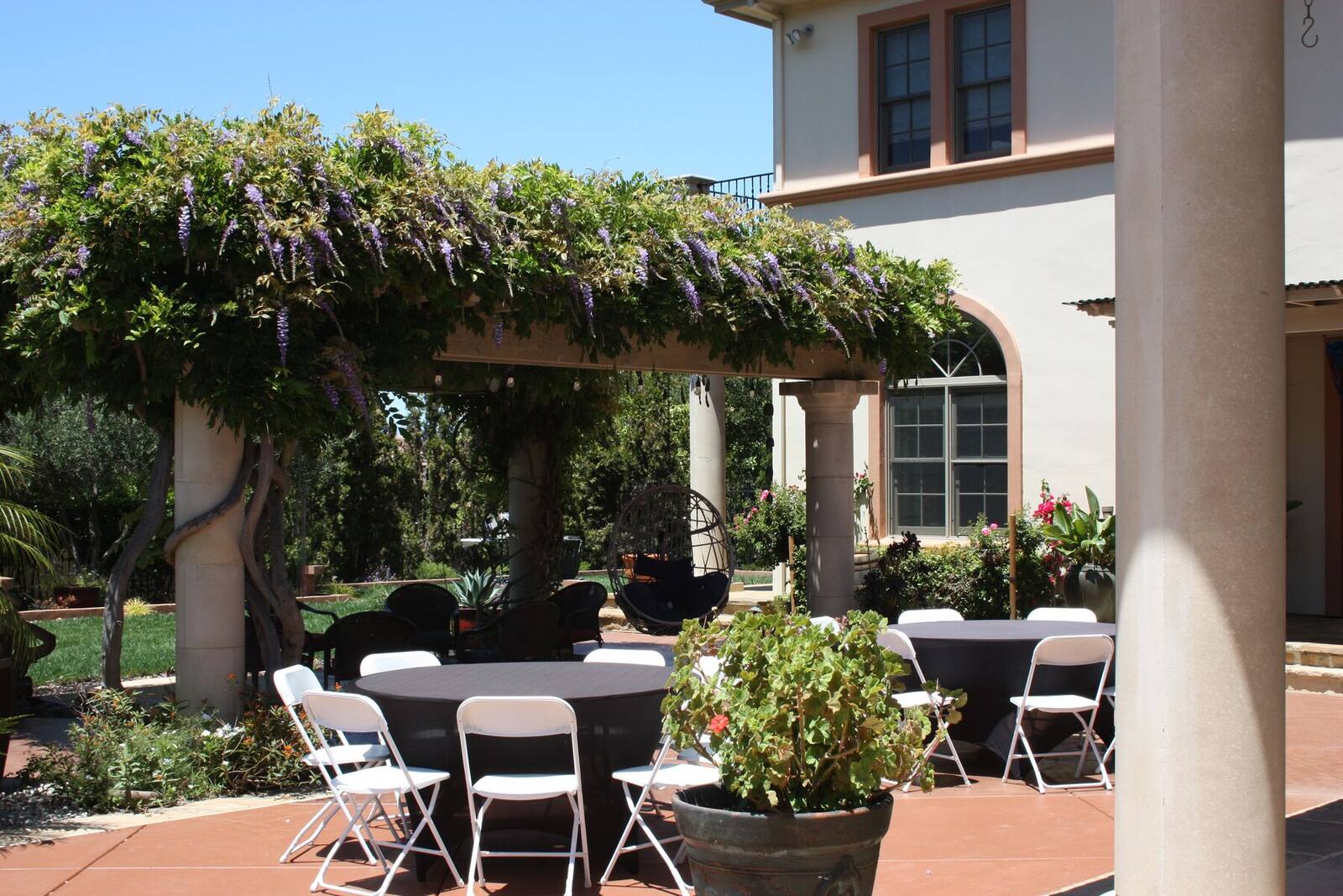 A shaded dining terrace prepared for gathering and entertaining.