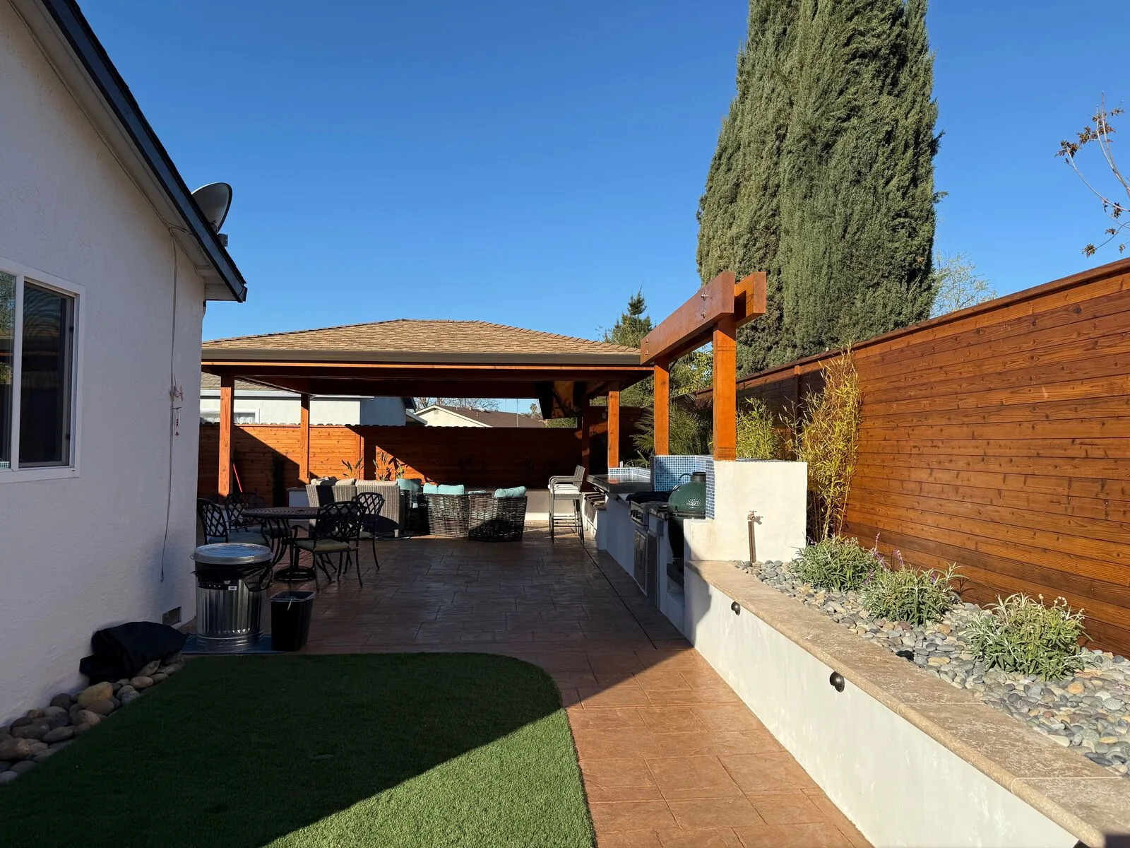 The completed Hernandez backyard looking past the lawn and dining area toward the pavilion.